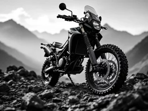 Adventure motorcycle with long-travel suspension on rocky mountain terrain in dramatic black and white lighting