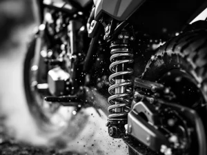 Adventure motorcycle rear suspension shock absorber with chrome springs and precision components in dramatic black and white