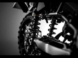 Adventure motorcycle rear suspension system with compressed shock absorber and linkage in black and white close-up