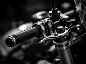 Motorcycle steering damper mounted on adventure bike handlebar with precision-machined aluminum components in black and white