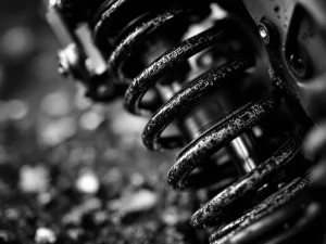 Adventure motorcycle rear suspension spring and shock absorber with preload adjuster ring in dramatic black and white