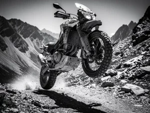 CFMOTO 450 MT adventure motorcycle airborne over rocky dirt trail, suspension compressed on landing, rugged mountain terrain in background.